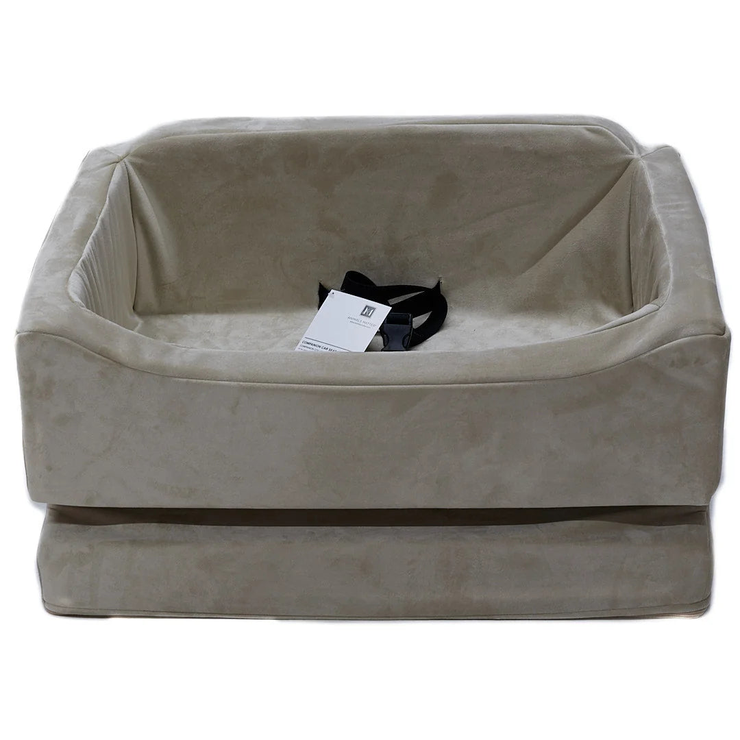 Animals Matter Companion Car Seat - Camel luxury dog car seat on a white studio background, featuring a plush camel travel seat with black safety straps.
