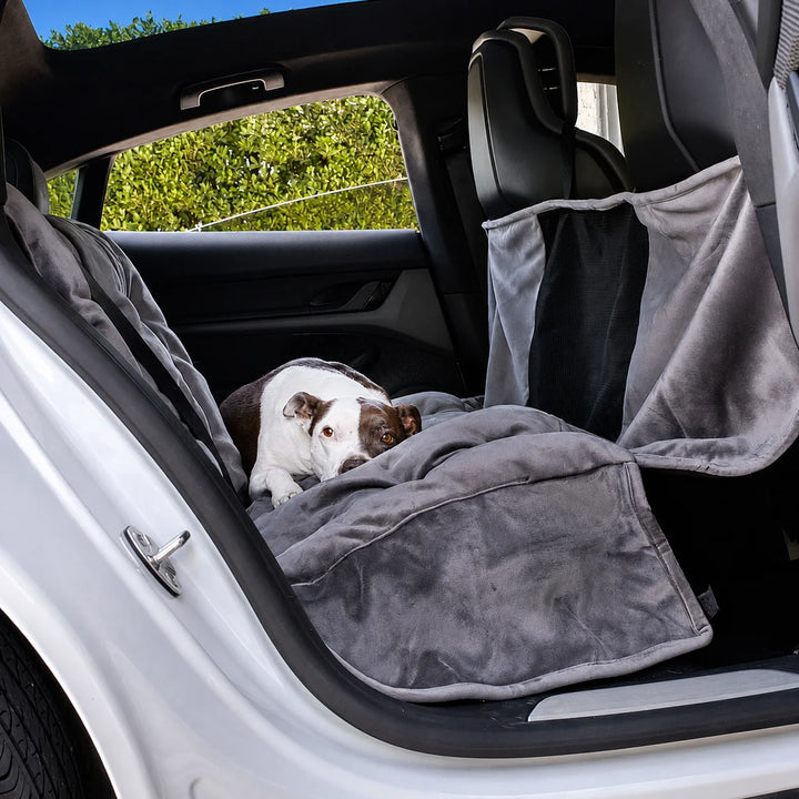 Animals Matter Companion Travel Hammock dog car hammock in a luxury vehicle, featuring a brown and white dog resting on a plush charcoal rear-seat hammock.