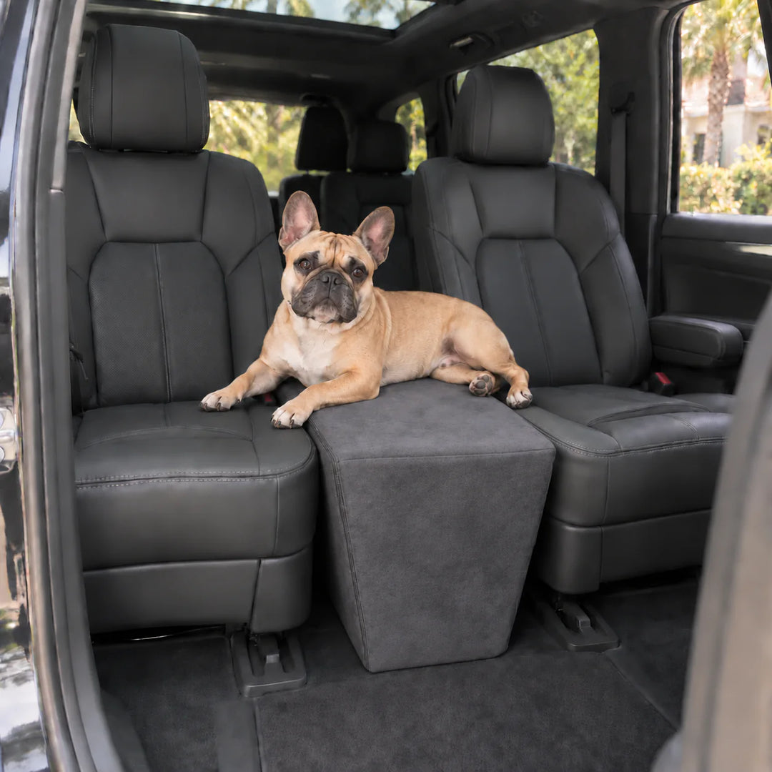 French Bulldog resting on the Charcoal XL Back Seat Extender, which spans the gap between two captain's chairs