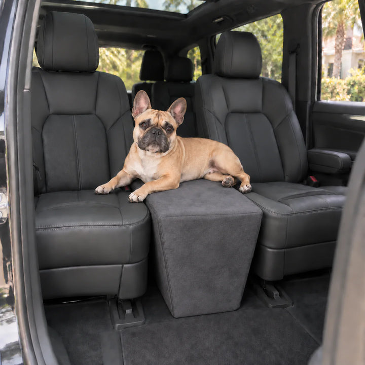 French Bulldog resting on the Charcoal XL Back Seat Extender, which spans the gap between two captain's chairs